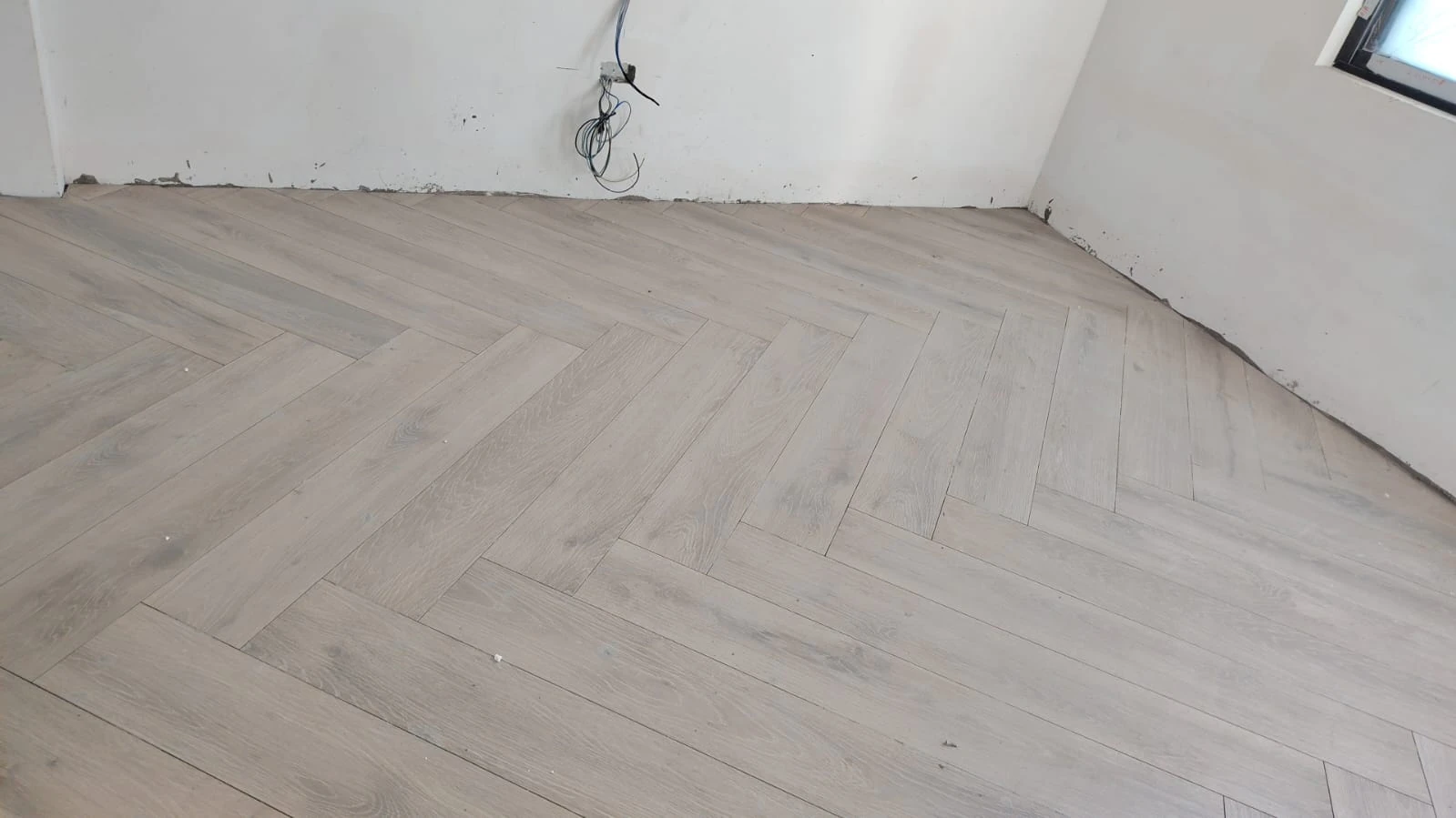 Company-supplied herringbone floor installation photograph
