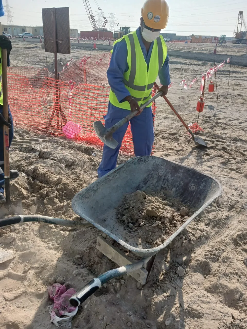 Site clearance with workers in protective gear